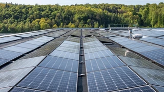 Solar panels installed on the roof of a modern building, harnessing renewable energy from sunlight.