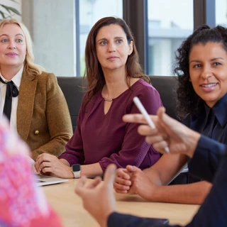 A team of professionals gathered at a conference table for a collaborative discussion.