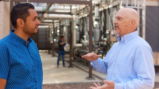 Colleagues in discussion, located in front of the Cooling towers